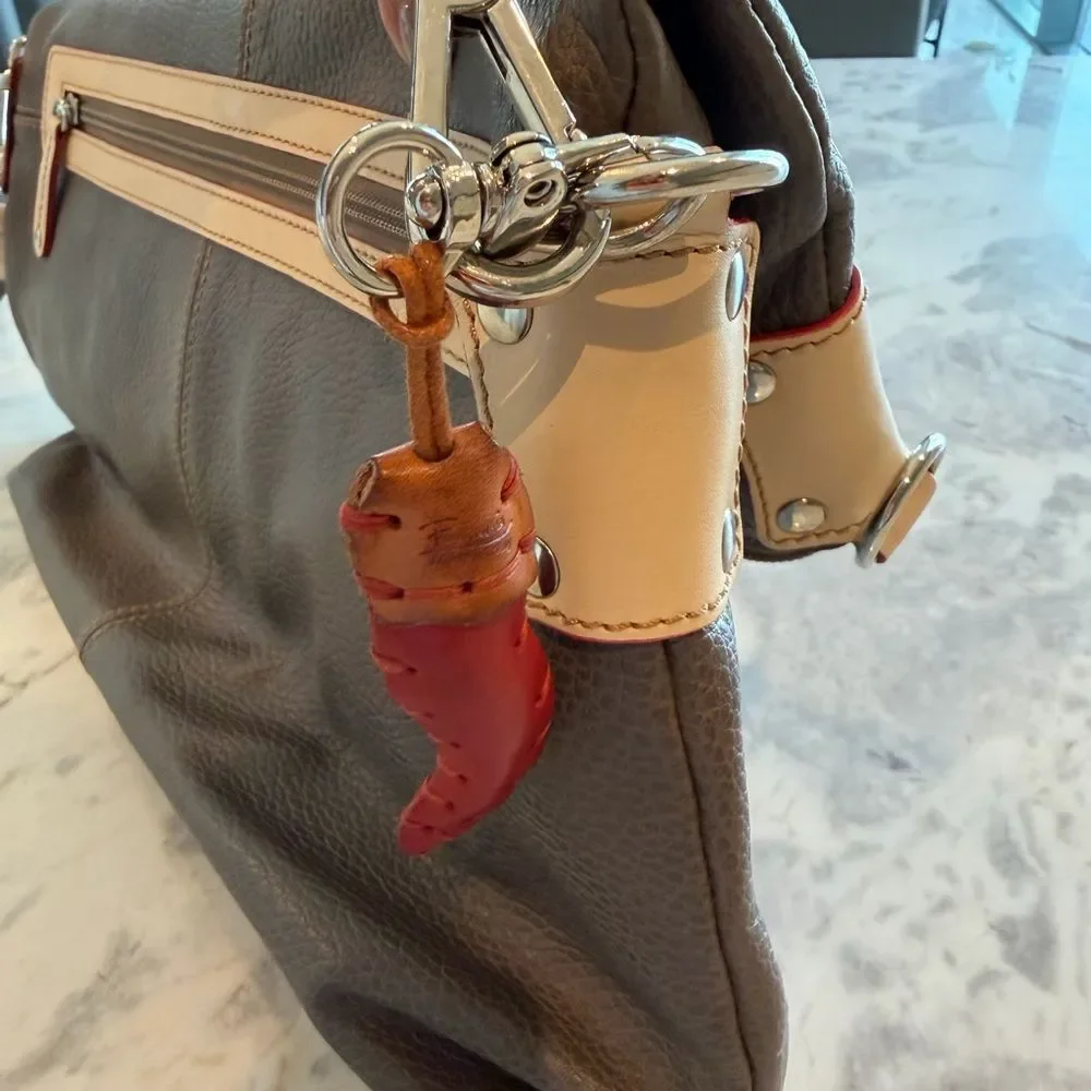Grey Leather crossbody bag with Cream Handles and Red piping across the lining